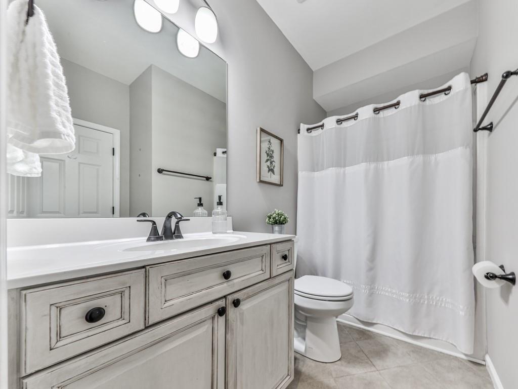 619 Riverbend Way Canton, GA 30114 - Photo 20 of 76 a bathroom with a sink a toilet and a mirror