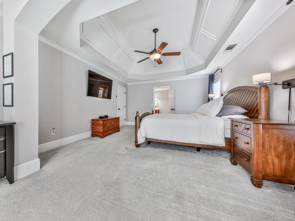 619 Riverbend Way Canton, GA 30114 - Photo 28 of 76 a bedroom with bed and a chandelier