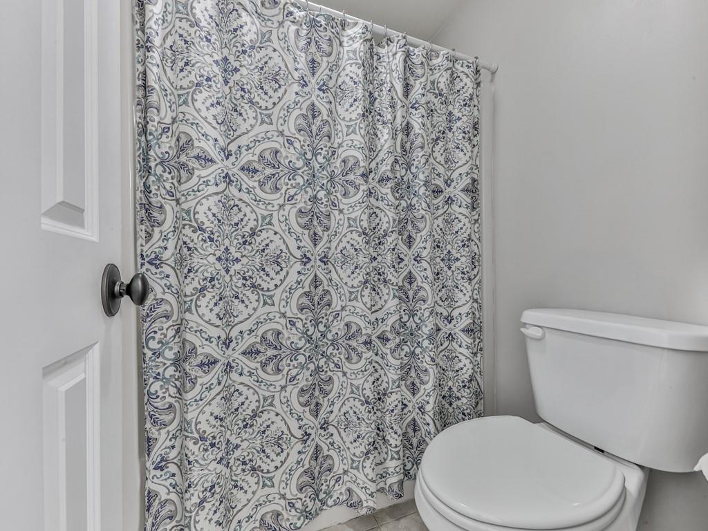 619 Riverbend Way Canton, GA 30114 - Photo 37 of 76 a white toilet sitting next to a shower curtain