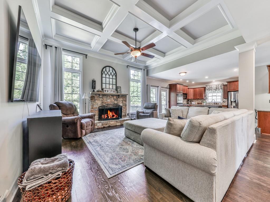 619 Riverbend Way Canton, GA 30114 - Photo 4 of 76 a living room with furniture a fireplace and a chandelier