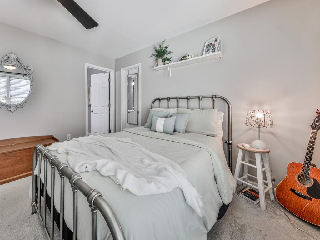 619 Riverbend Way Canton, GA 30114 - Photo 41 of 76 a bedroom with a bed and a chandelier