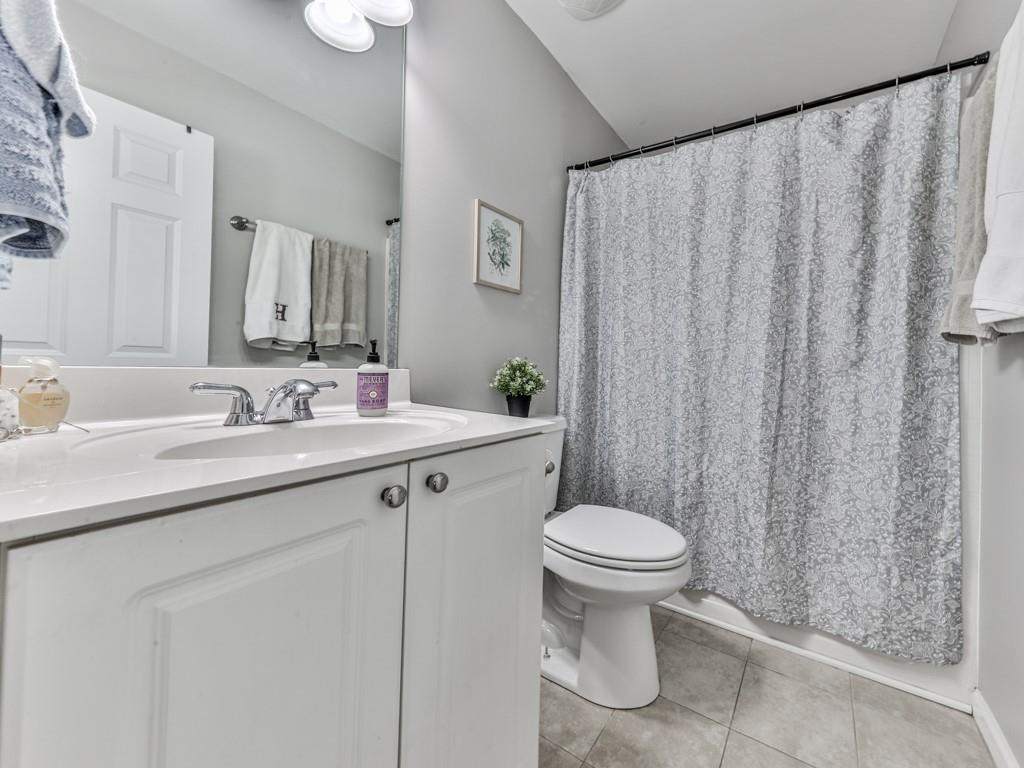 619 Riverbend Way Canton, GA 30114 - Photo 42 of 76 a bathroom with a granite countertop sink toilet and a mirror