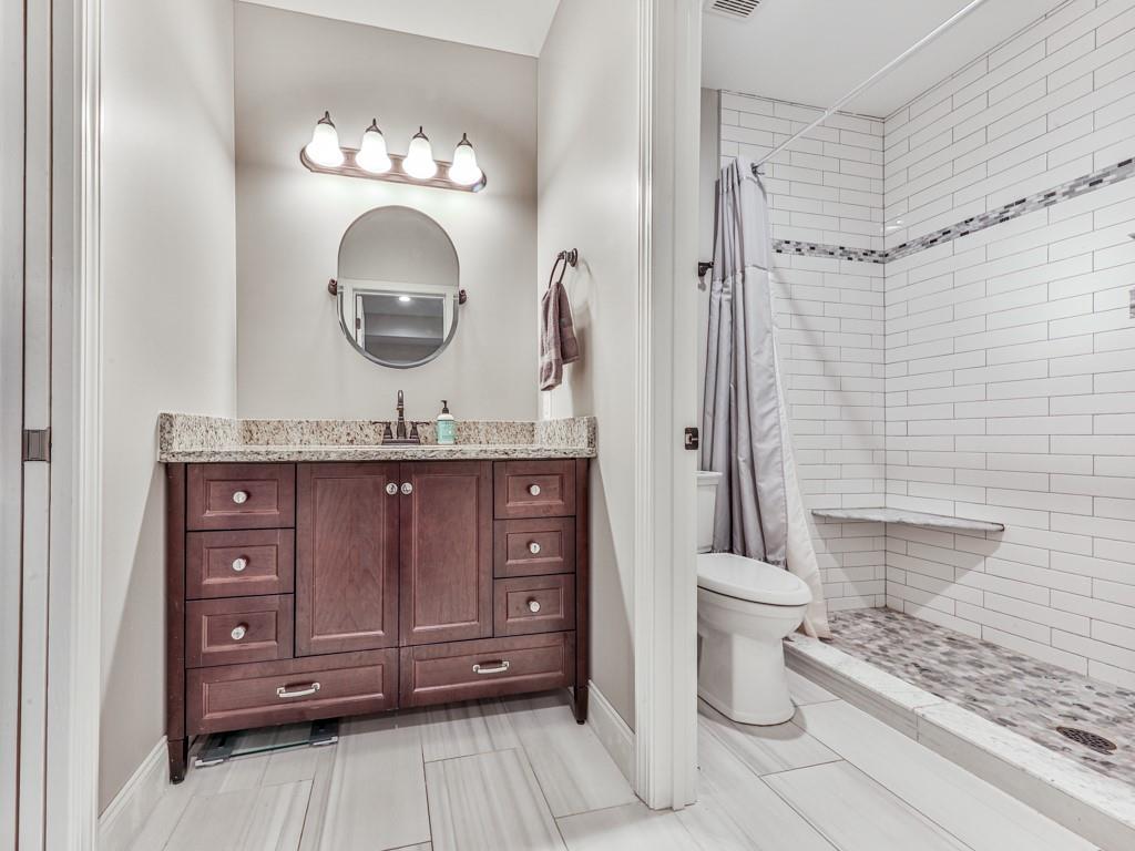 619 Riverbend Way Canton, GA 30114 - Photo 47 of 76 a bathroom with a granite countertop toilet sink and mirror