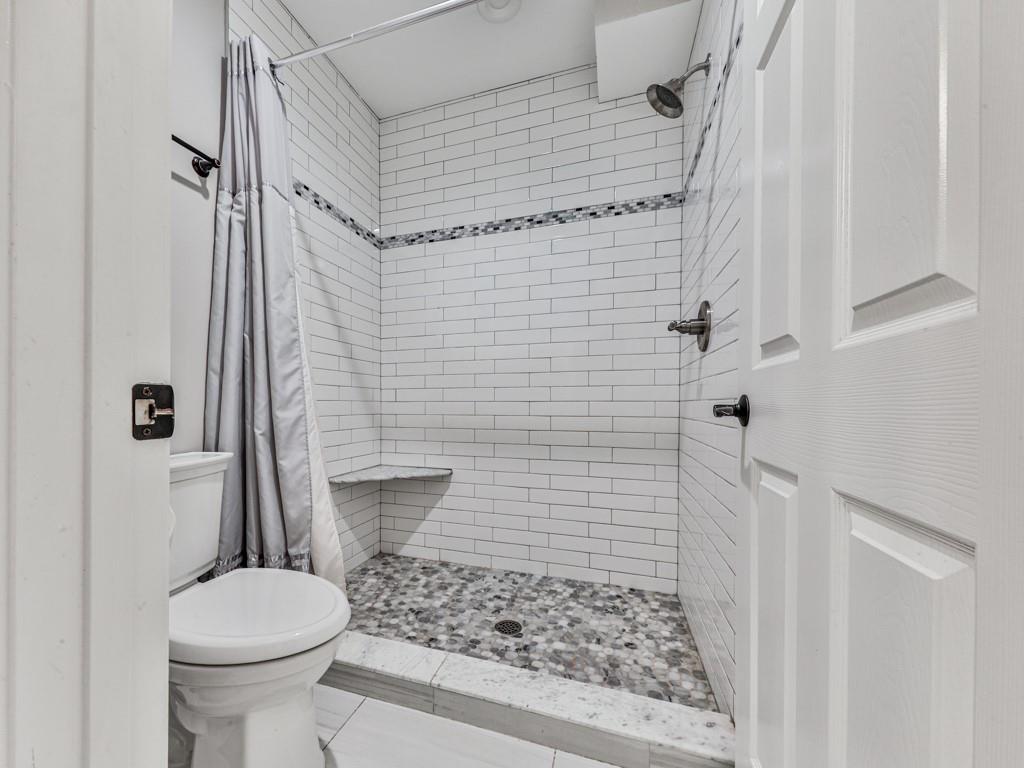 619 Riverbend Way Canton, GA 30114 - Photo 48 of 76 a bathroom with a toilet and a shower