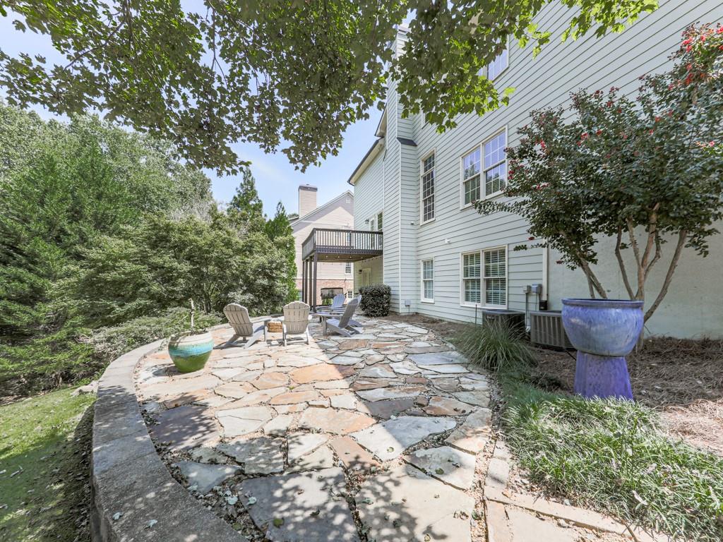 619 Riverbend Way Canton, GA 30114 - Photo 59 of 76 a view of a patio with table and chairs under an umbrella