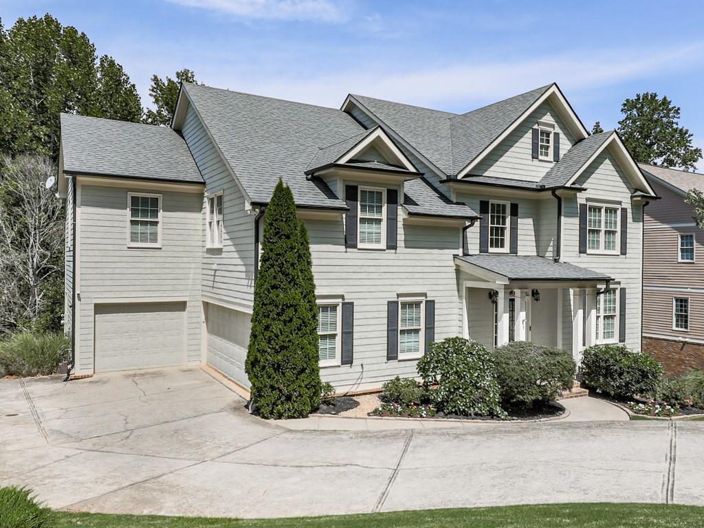 619 Riverbend Way Canton, GA 30114 - Photo 76 of 76 a front view of a house with a yard and potted plants