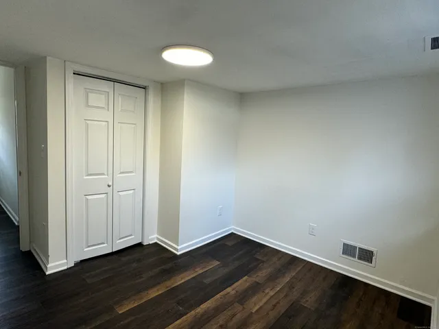 a view of an empty room and wooden floor