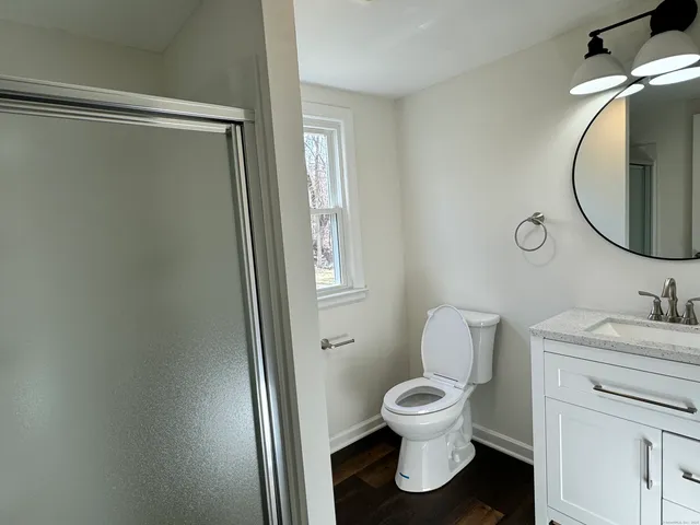 a bathroom with a toilet sink and a mirror