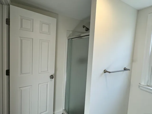 a bathroom with a glass shower door