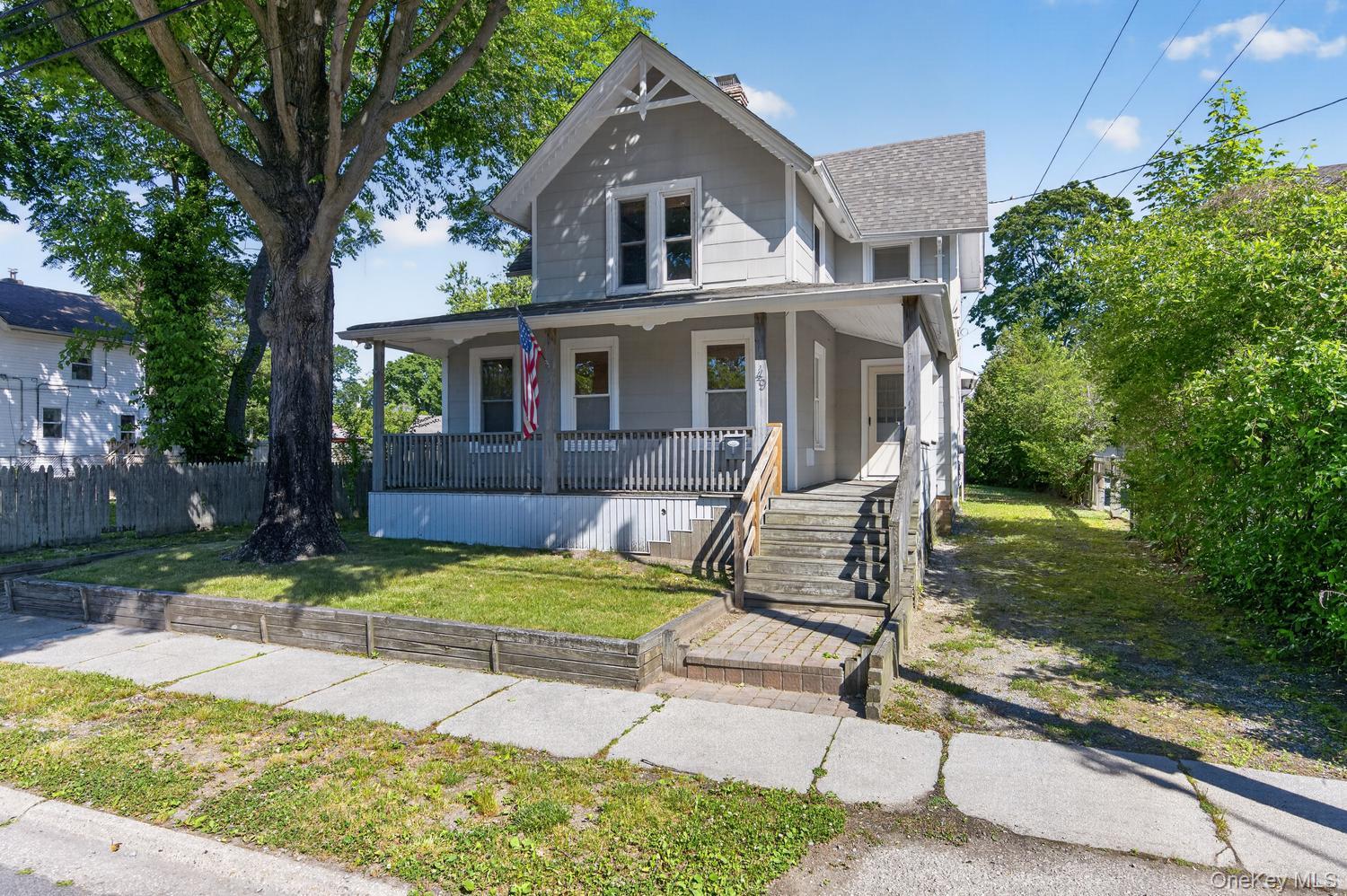 49 Cedar Street Babylon, NY 11702 - Photo 2 of 20 a front view of house with yard porch and green space