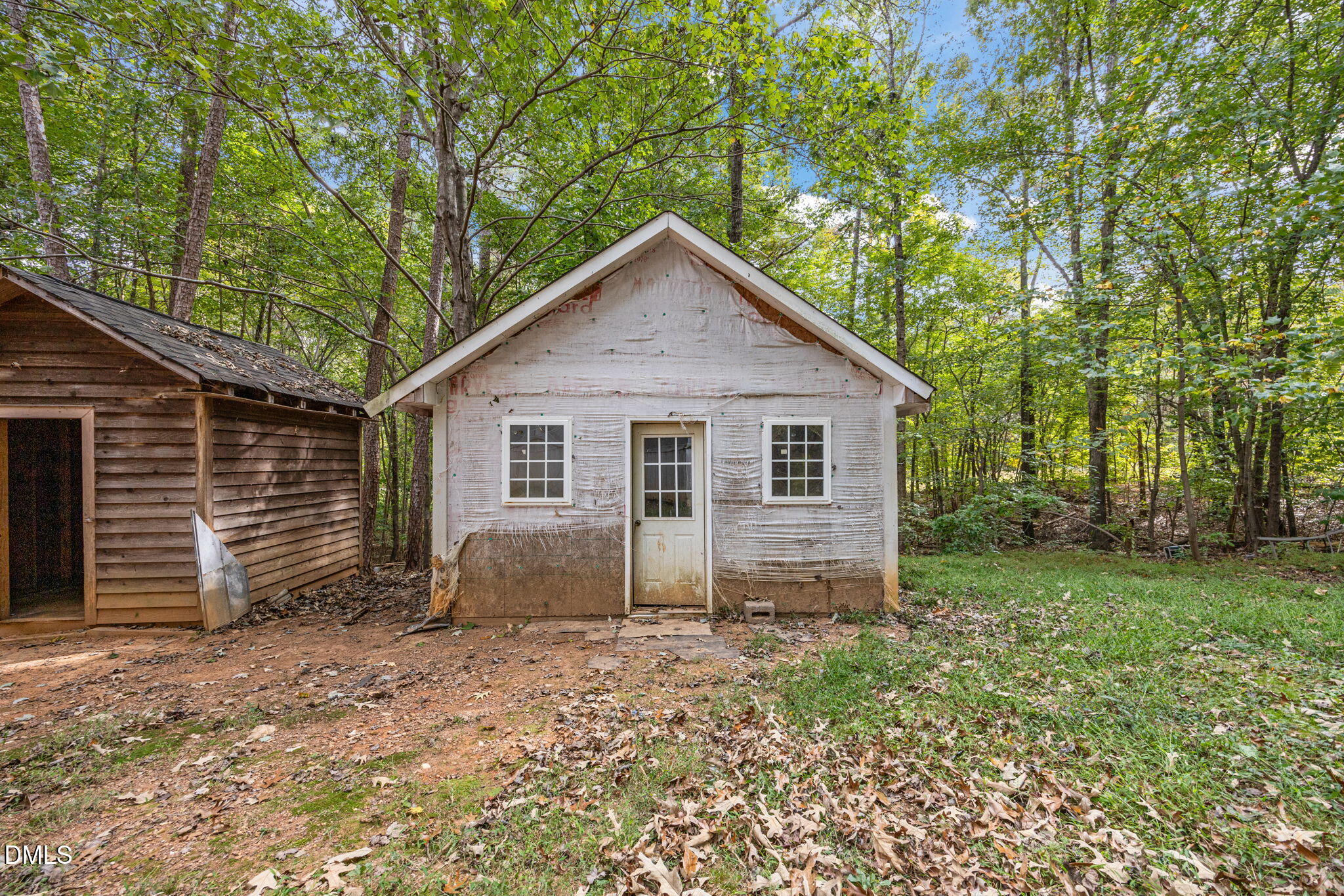 6933 Big Woods Road Graham, NC 27253 - Photo 12 of 32 a view of a house with a yard and large tree