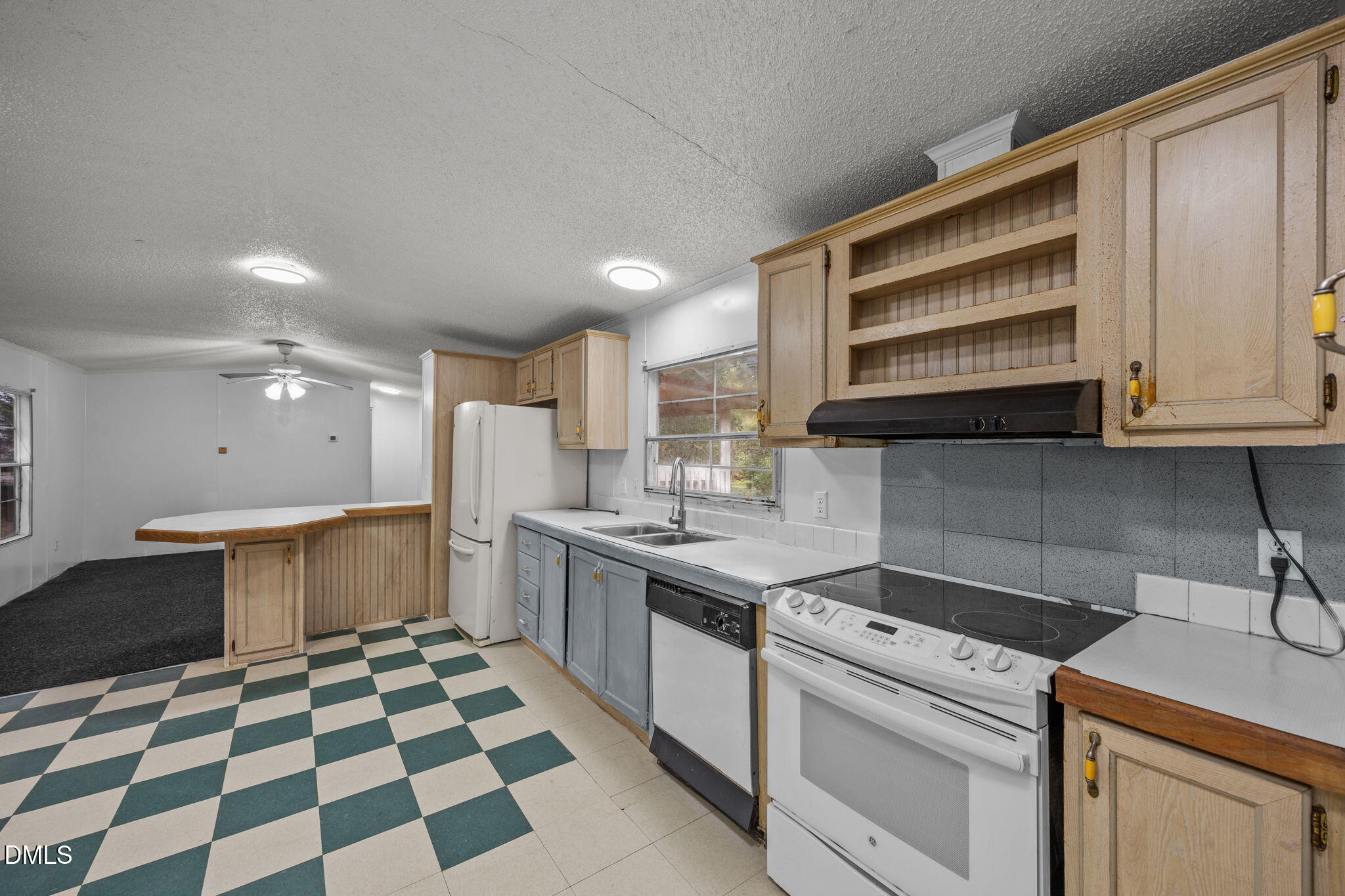 6933 Big Woods Road Graham, NC 27253 - Photo 14 of 32 a kitchen with a sink a stove and cabinets