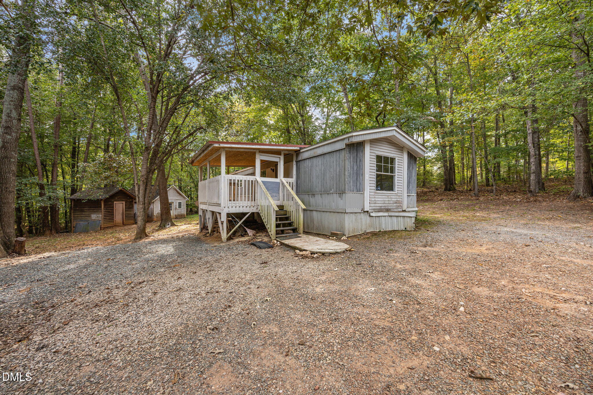 6933 Big Woods Road Graham, NC 27253 - Photo 3 of 32 a view of a house with a yard and large tree