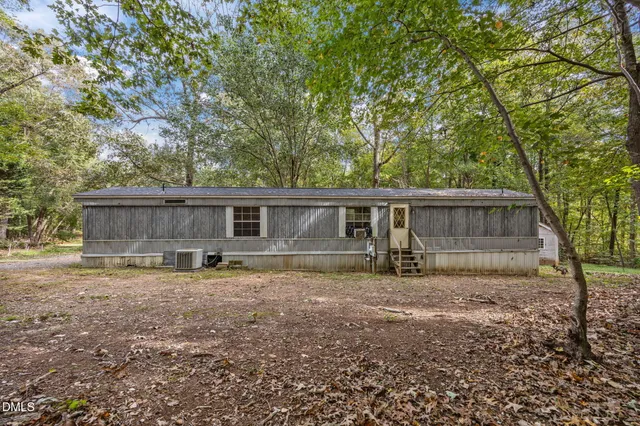 a view of a house with a large tree and a big yard