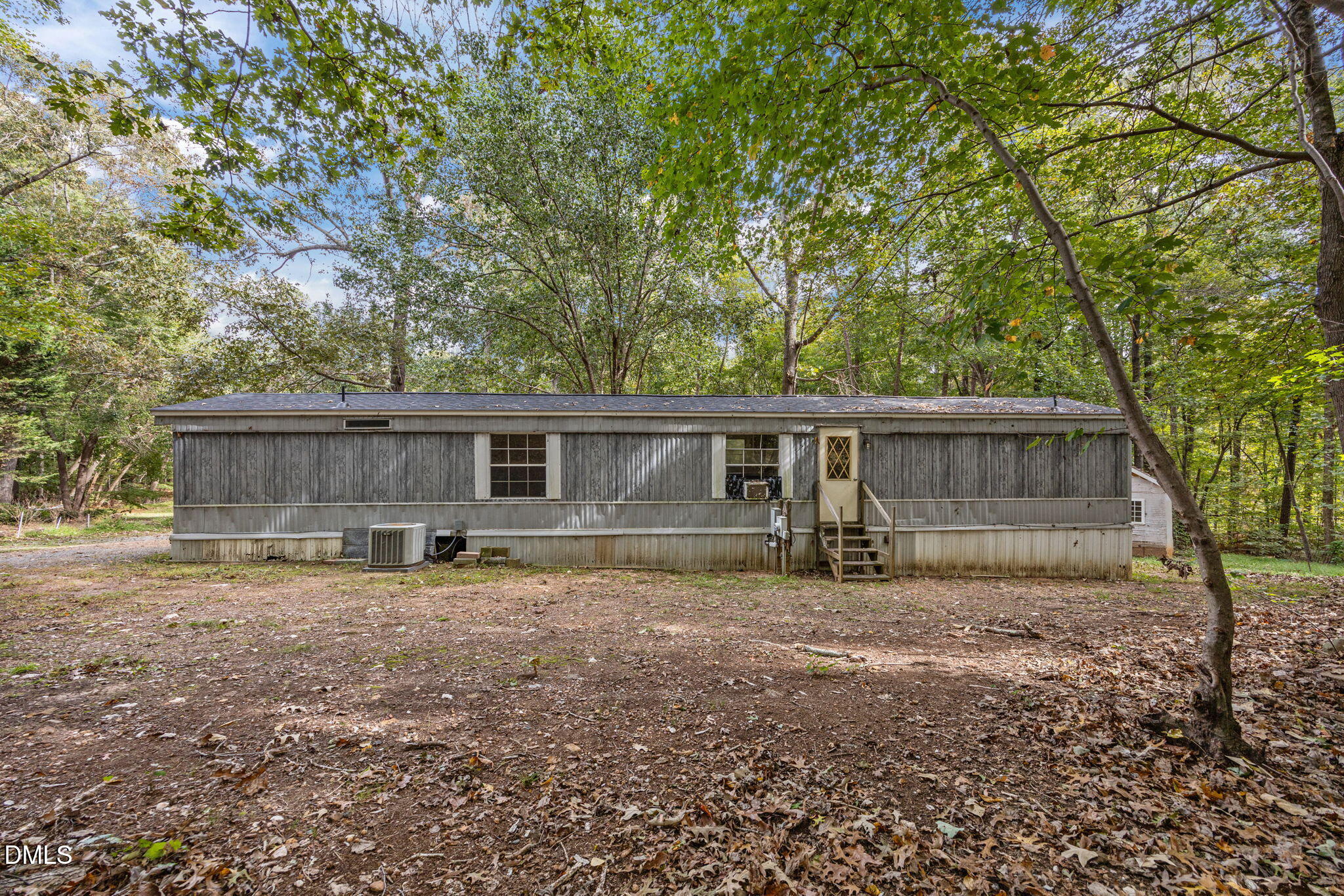 6933 Big Woods Road Graham, NC 27253 - Photo 4 of 32 a view of a house with a large tree and a big yard