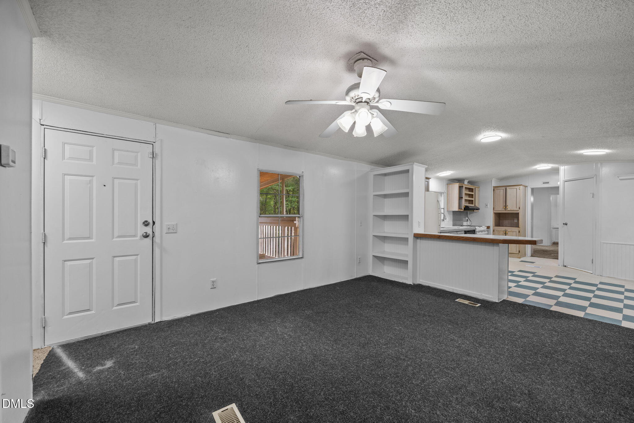 6933 Big Woods Road Graham, NC 27253 - Photo 9 of 32 a view of an empty room with window and cabinet