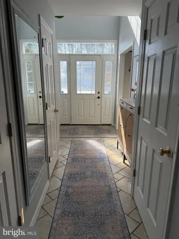 a view of a hallway with wooden floor and a glass door