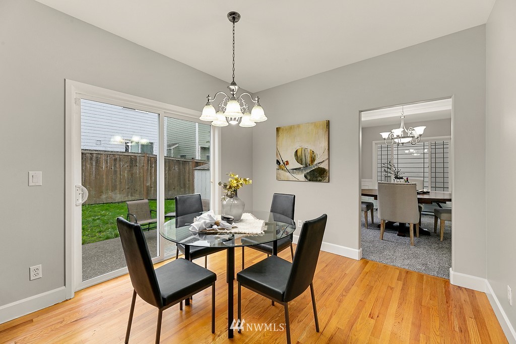 2222 Smithers Avenue South Renton, WA 98055 - Photo 11 of 25 a dining room with furniture a chandelier and wooden floor