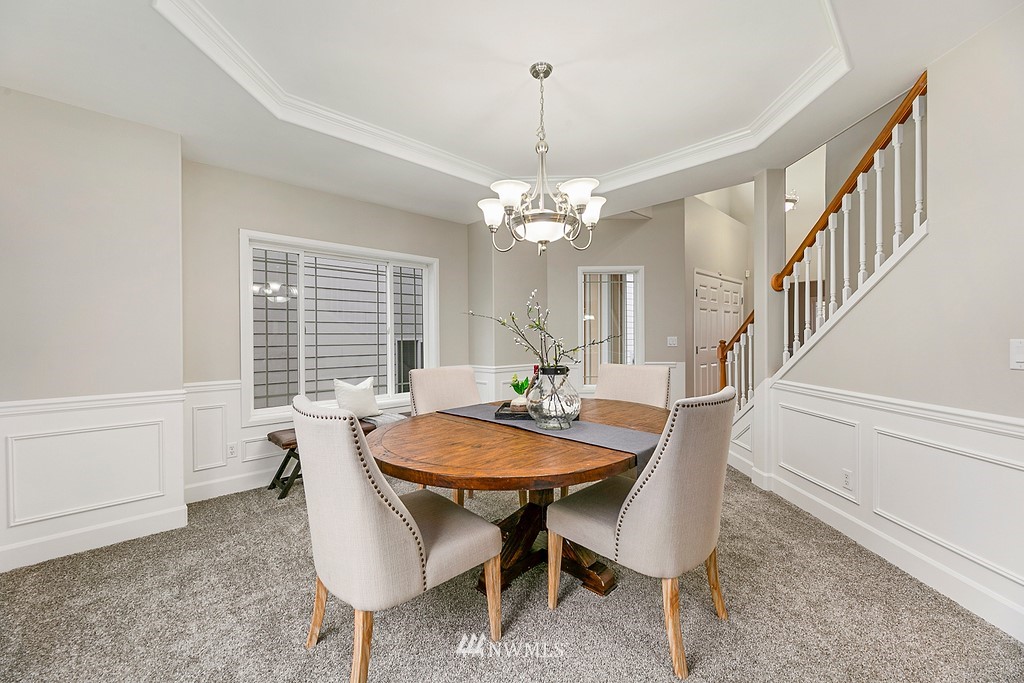 2222 Smithers Avenue South Renton, WA 98055 - Photo 13 of 25 a dining room with furniture a chandelier and wooden floor