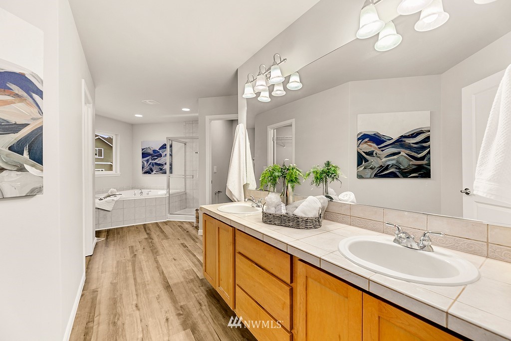 2222 Smithers Avenue South Renton, WA 98055 - Photo 19 of 25 a spacious bathroom with a granite countertop sink a mirror and a bathtub