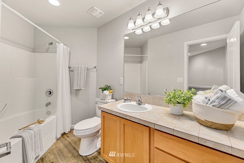 2222 Smithers Avenue South Renton, WA 98055 - Photo 24 of 25 a bathroom with a granite countertop sink a toilet and a bathtub