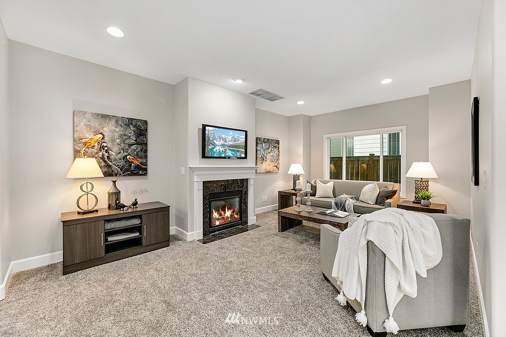 2222 Smithers Avenue South Renton, WA 98055 - Photo 7 of 25 a living room with furniture a fireplace and a large window