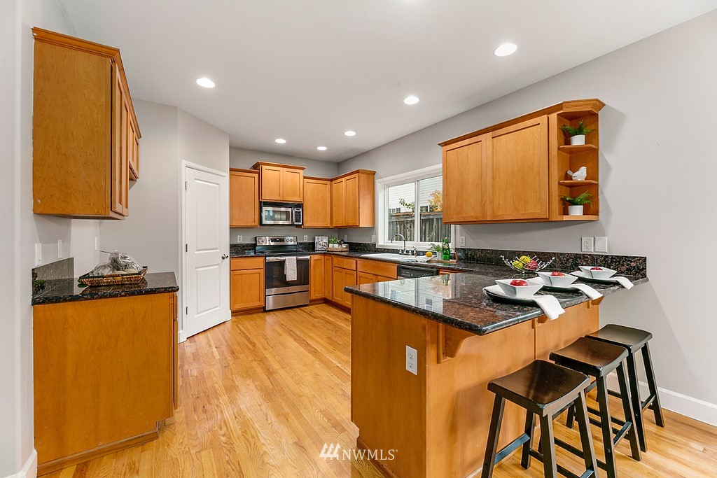2222 Smithers Avenue South Renton, WA 98055 - Photo 8 of 25 a kitchen with a table chairs sink and cabinets