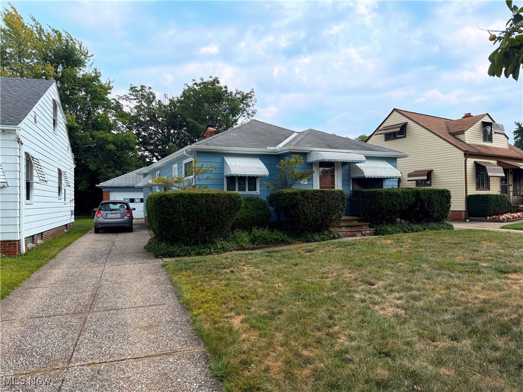 6271 Holburn Road Parma, OH 44129 - Photo 2 of 17 View of front of house featuring a front lawn and a garage
