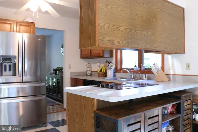 a kitchen with stainless steel appliances a sink a stove and a microwave