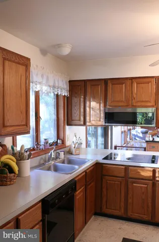 a kitchen with stainless steel appliances granite countertop a stove a microwave and a sink