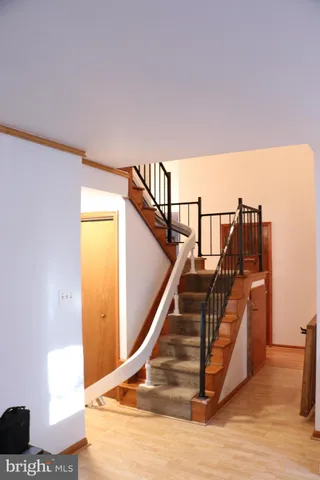 a bedroom with a bed and a night stand