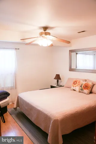 a bathroom with a granite countertop sink a mirror and a bathtub