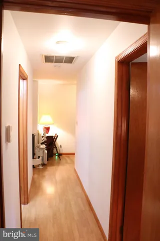a view of balcony with wooden floor and fence