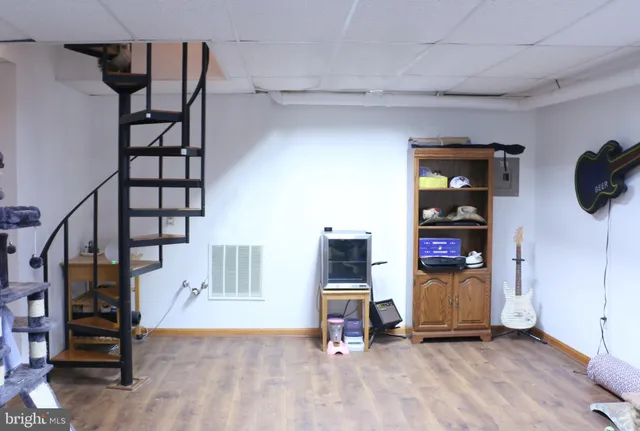 a view of a yard with plants and wooden fence