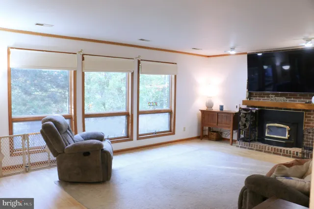 a kitchen with stainless steel appliances kitchen island granite countertop a refrigerator a stove and a sink with wooden floors