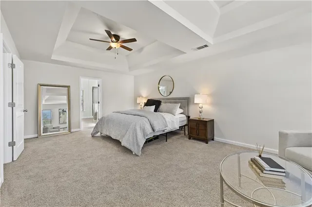 a bedroom with bed and a chandelier