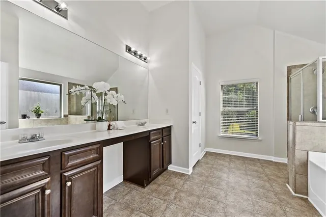 a spacious bathroom with a granite countertop sink mirror and a