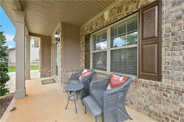 a balcony with furniture and a potted plant