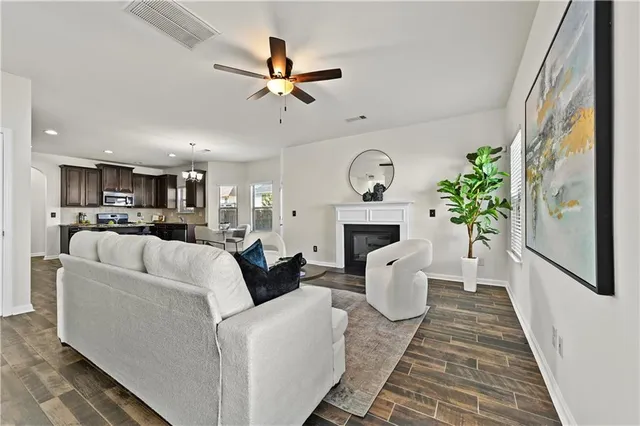 a living room with furniture a fireplace and a clock