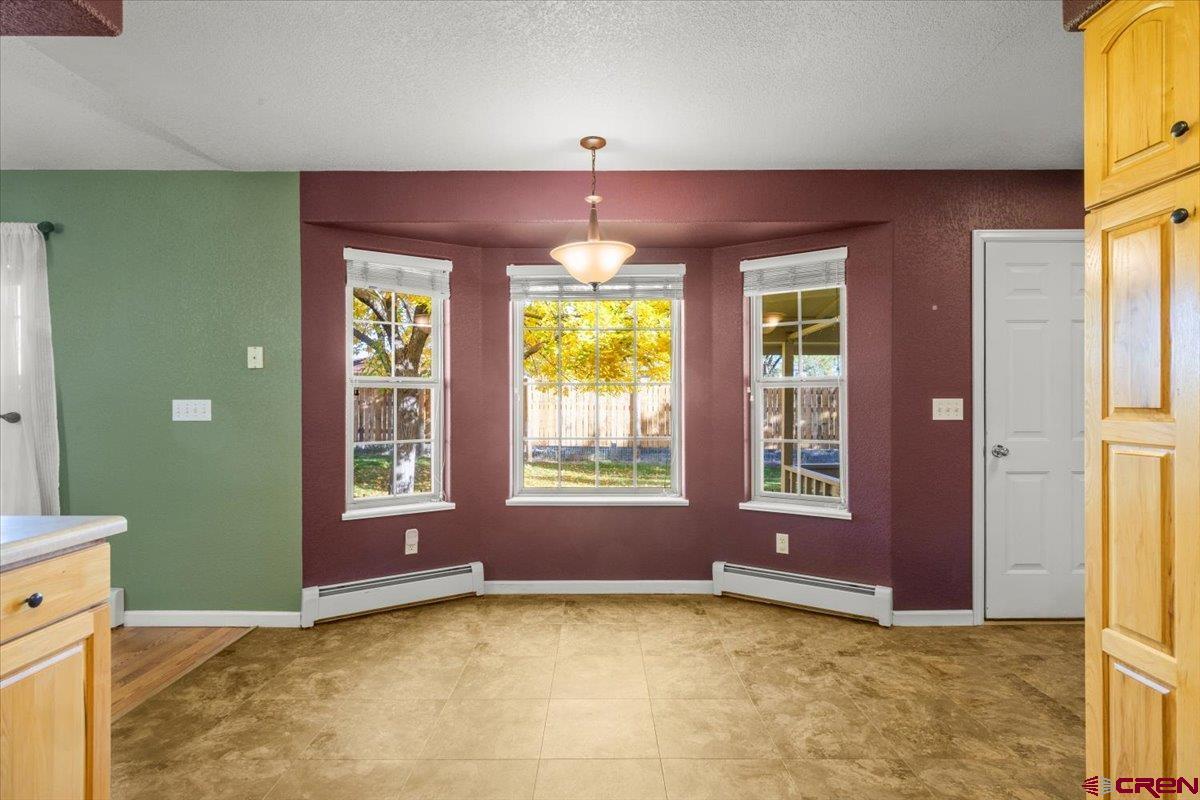 1600 Arland Road Montrose, CO 81401 - Photo 13 of 26 a view of an empty room with window and chandelier