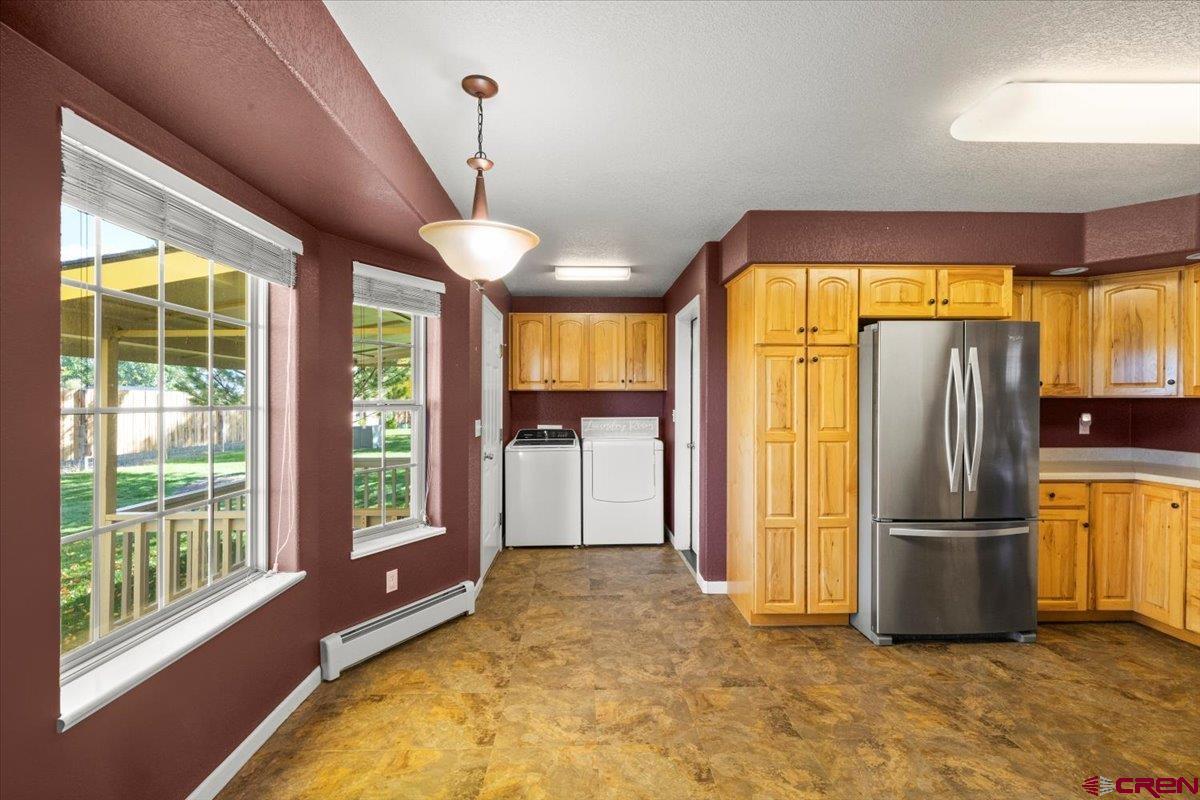 1600 Arland Road Montrose, CO 81401 - Photo 15 of 26 a view of a kitchen with a refrigerator and microwave