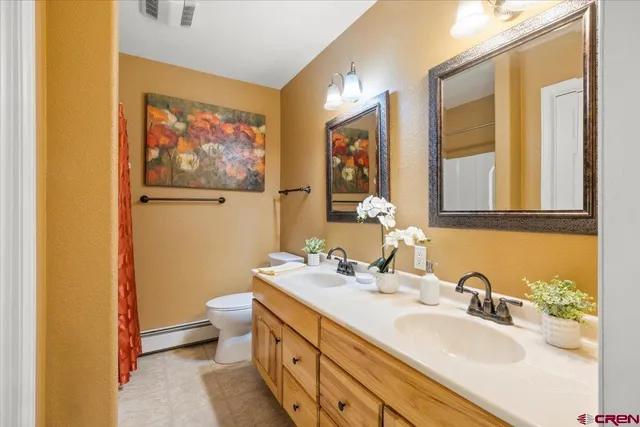 a bathroom with 2 sink and a mirror