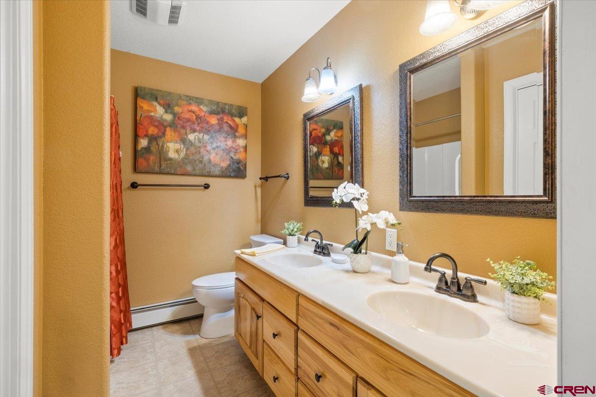 1600 Arland Road Montrose, CO 81401 - Photo 18 of 26 a bathroom with 2 sink and a mirror