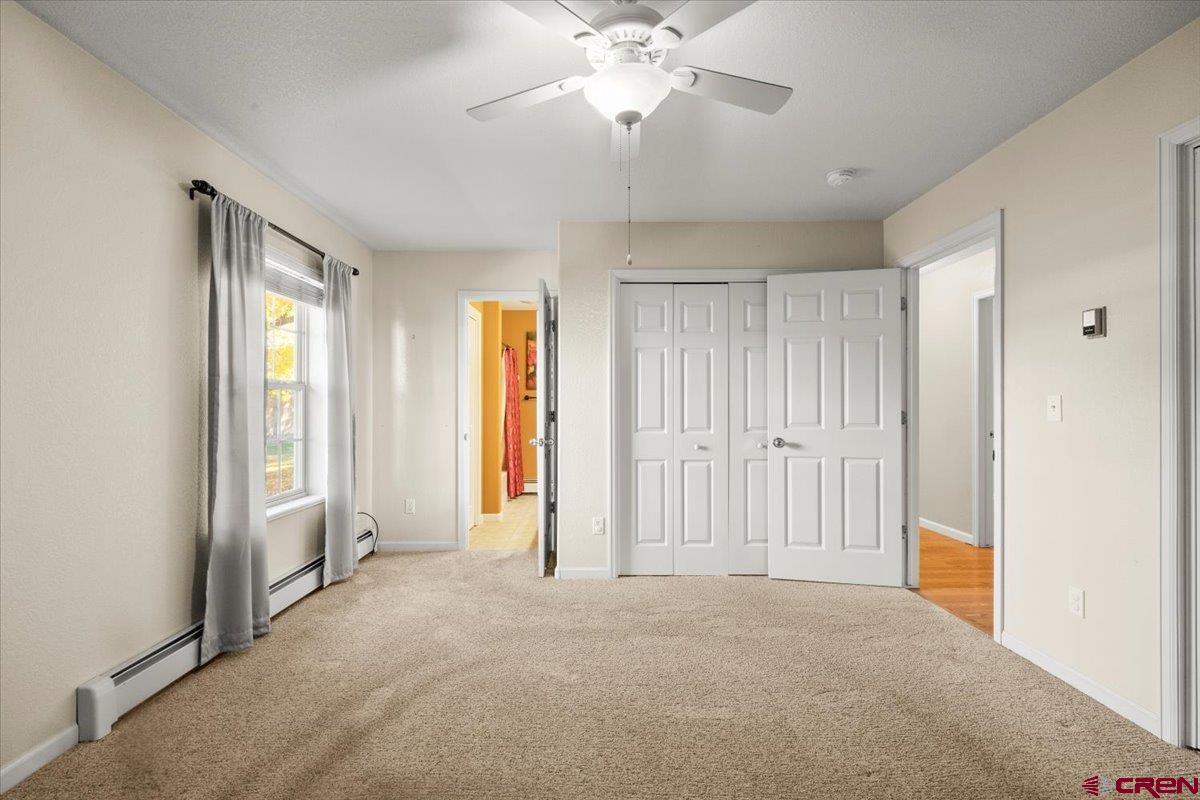 1600 Arland Road Montrose, CO 81401 - Photo 21 of 26 a view of a livingroom with a chandelier fan and windows