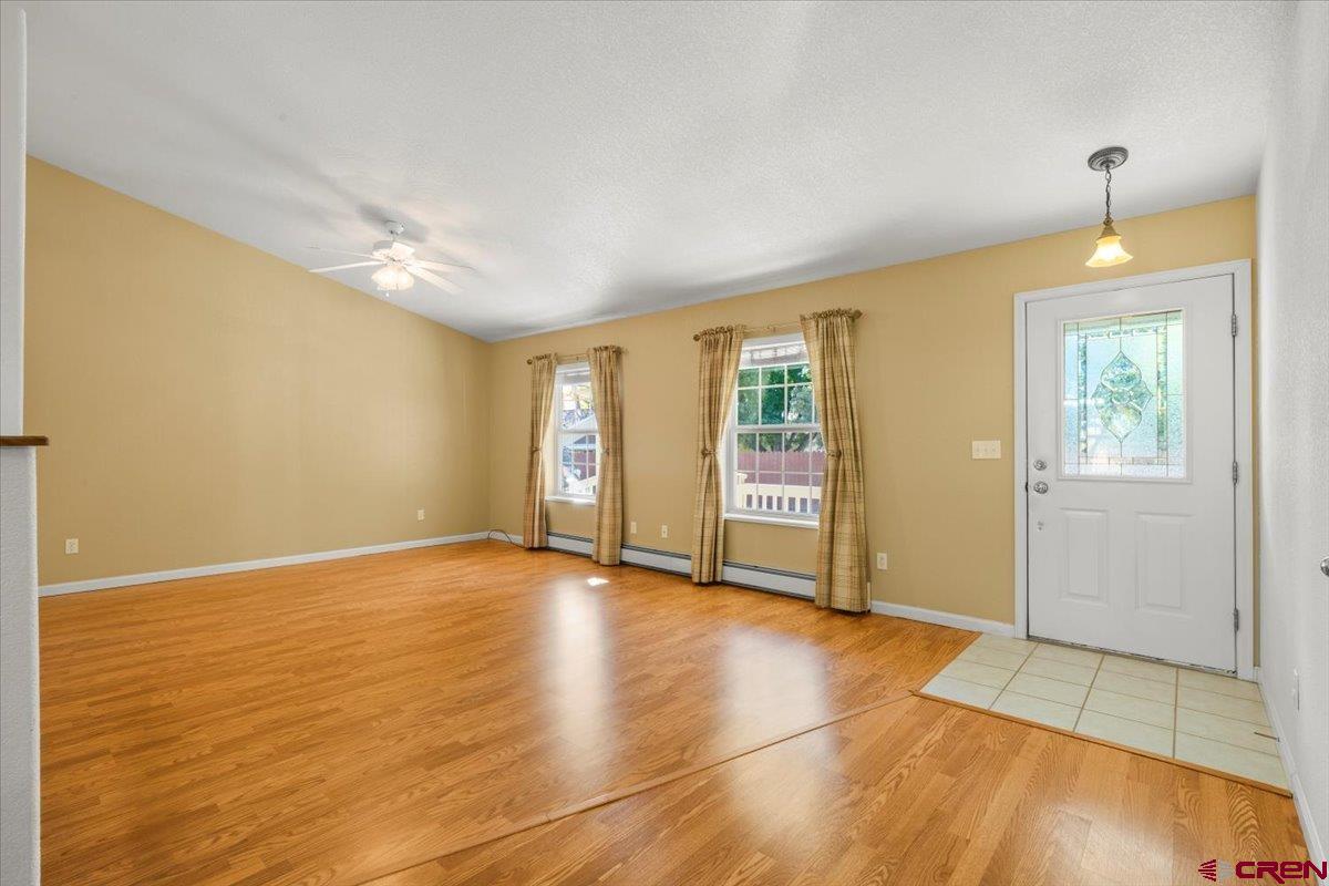 1600 Arland Road Montrose, CO 81401 - Photo 7 of 26 wooden floor in an empty room with a window