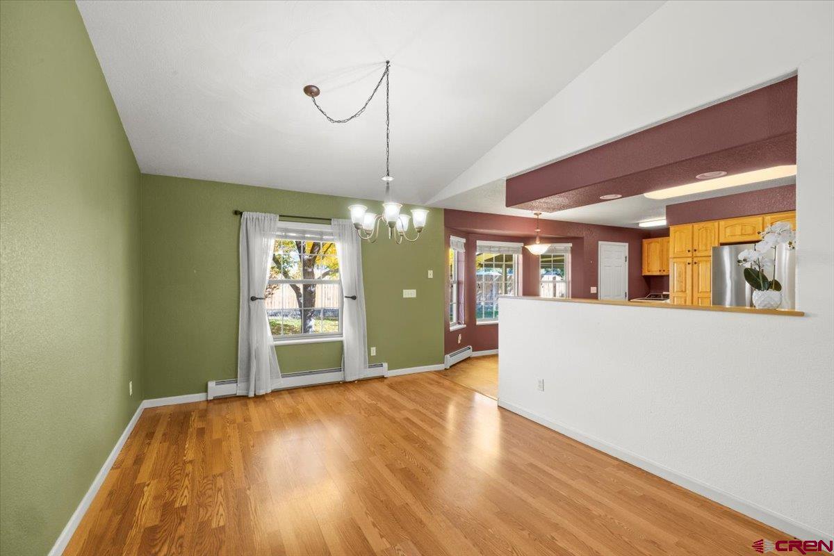 1600 Arland Road Montrose, CO 81401 - Photo 8 of 26 a view of an empty room with window and wooden floor