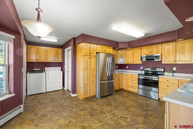 a kitchen with refrigerator cabinets and wooden floor