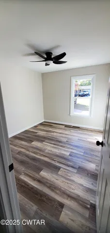 a view of room with window and wooden floor
