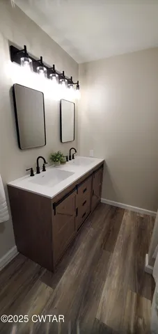 a bathroom with a double vanity sink and mirror