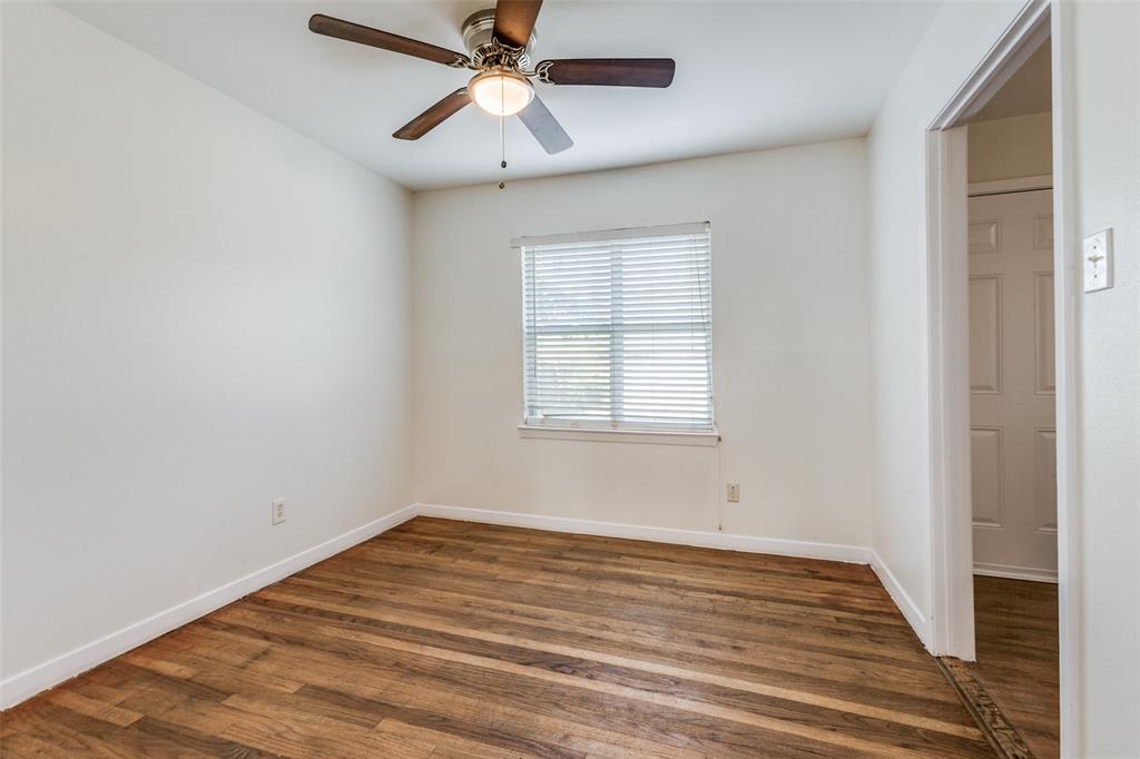 10815 Ruth Ann Drive Dallas, TX 75228 - Photo 4 of 12 an empty room with wooden floor fan and windows